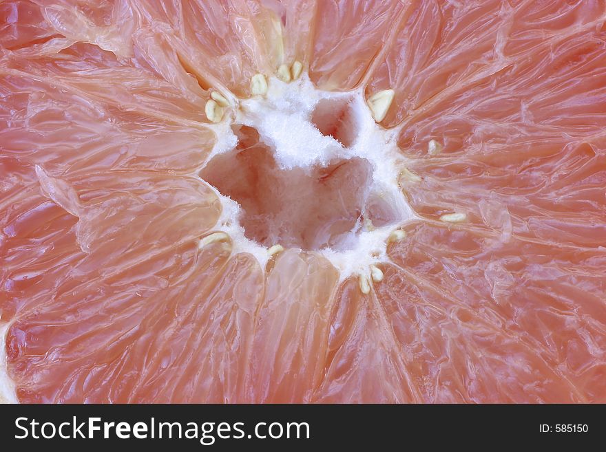 A tempting full frame cross section of delicious Pink grapefruit detail. A tempting full frame cross section of delicious Pink grapefruit detail.