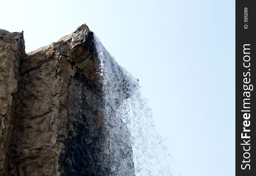 An artificial waterfall, day view.