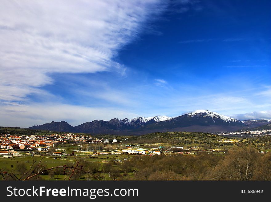 Village with snow mountains in the background and a nice sky. Village with snow mountains in the background and a nice sky