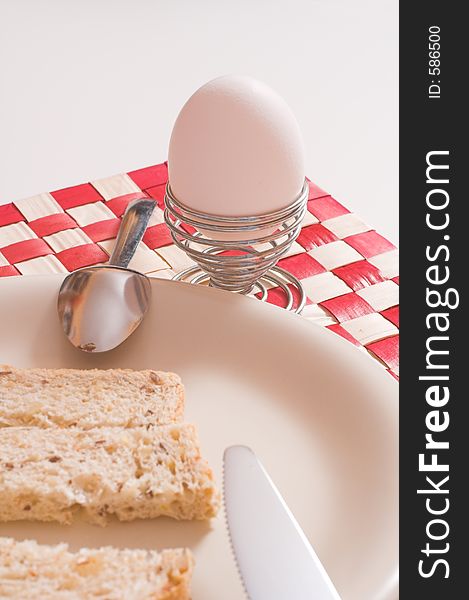 Egg and bread in plate over white. Egg and bread in plate over white