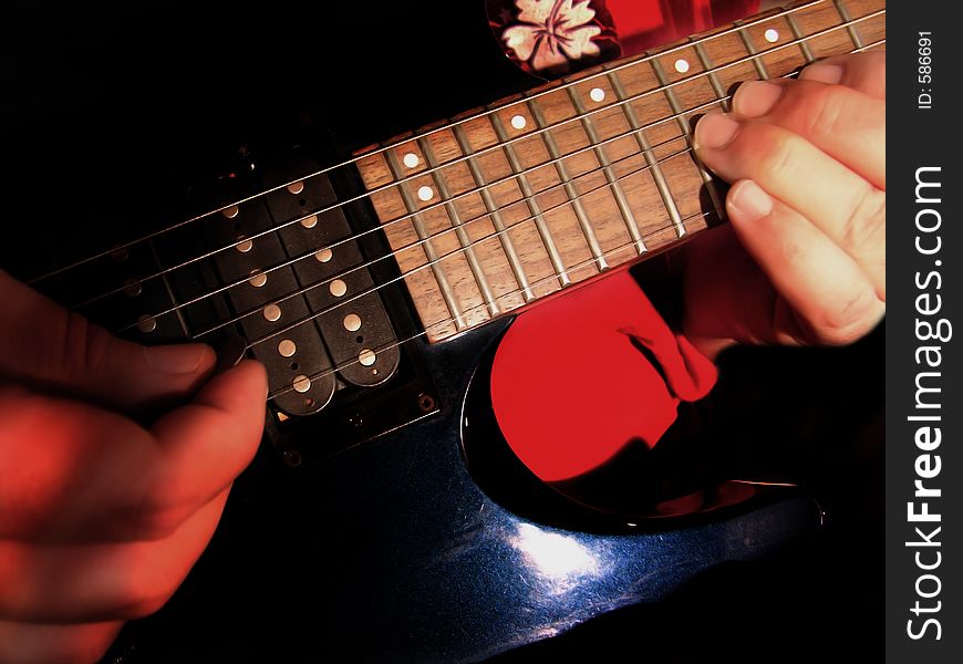Electric guitar being played by guitarist or musician
