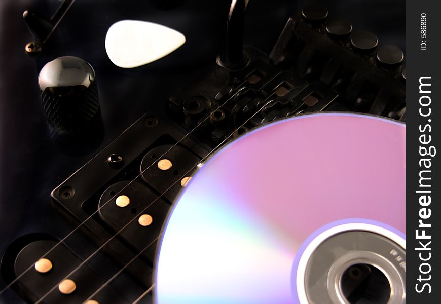 Making Music - Electric guitar compact disc and guitar pick. Making Music - Electric guitar compact disc and guitar pick