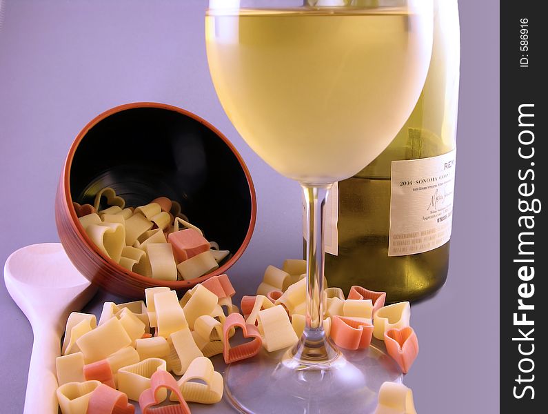 Heart shaped valentine pasta noodles with chardonnay wine. Heart shaped valentine pasta noodles with chardonnay wine