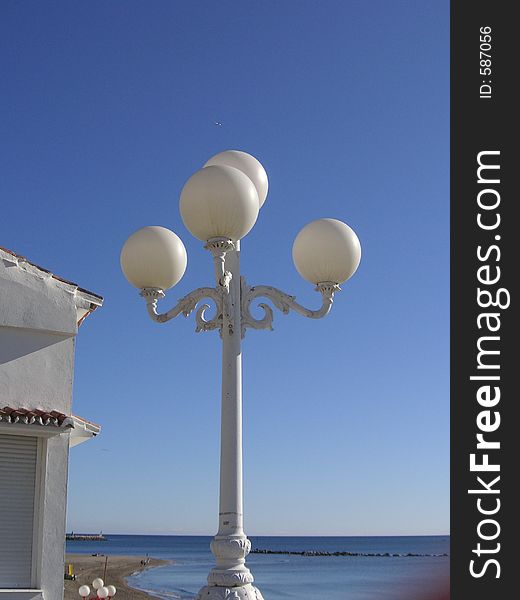 Globe street lighting against a blue sky