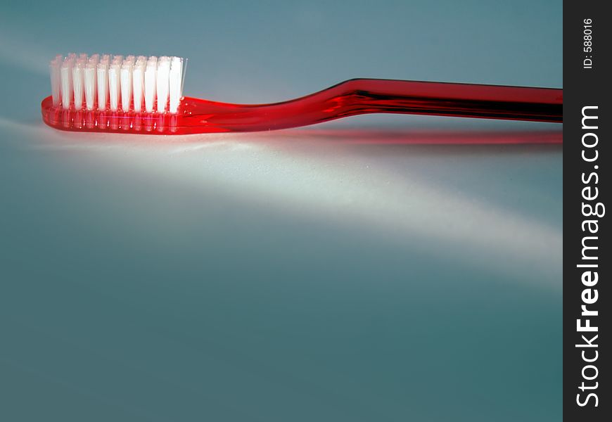 A bright red toothbrush is highlighted with room for text and titles below.