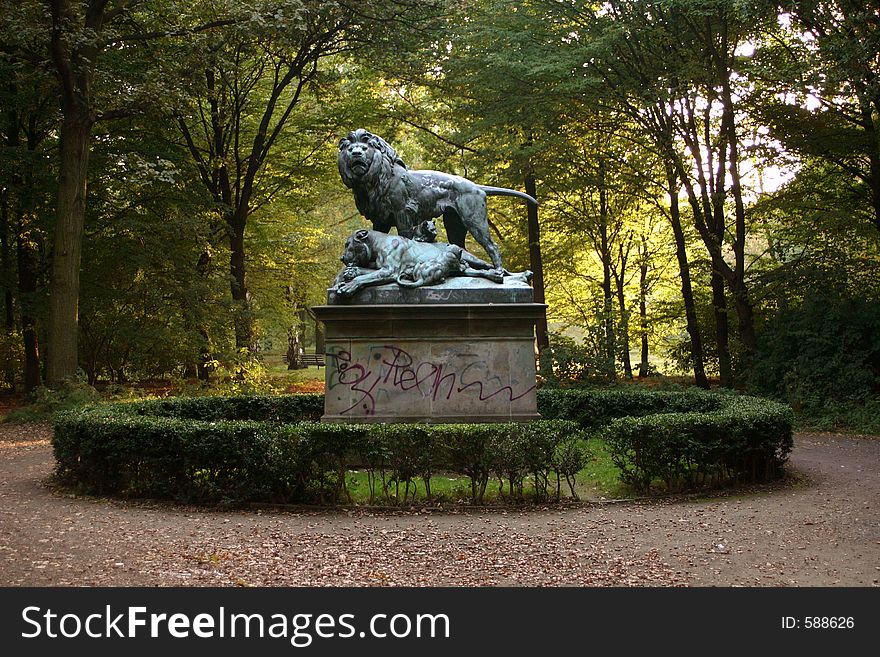 A statue with lions in a park