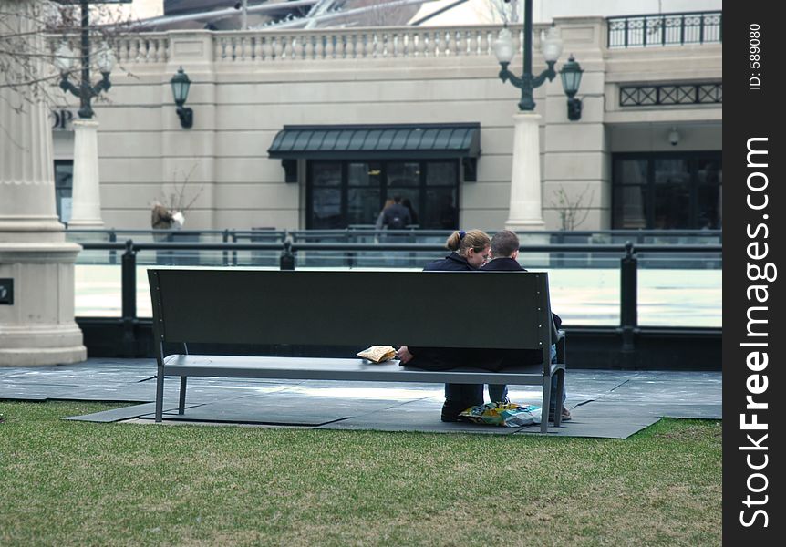 Young couple sitting on a park bench