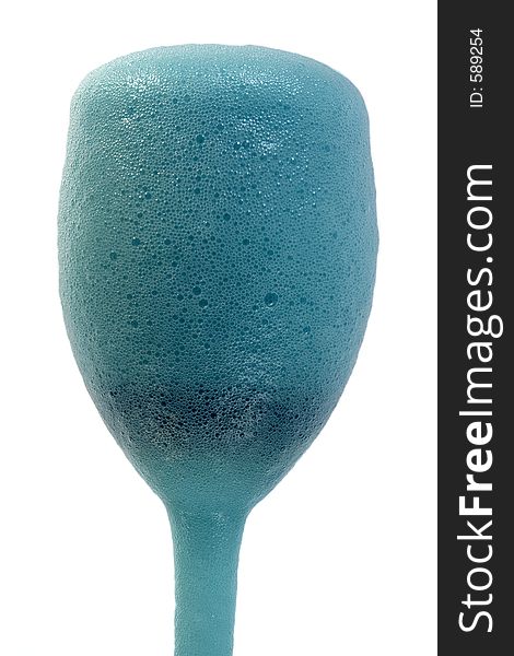 A blue frothy drink. A blue frothy drink