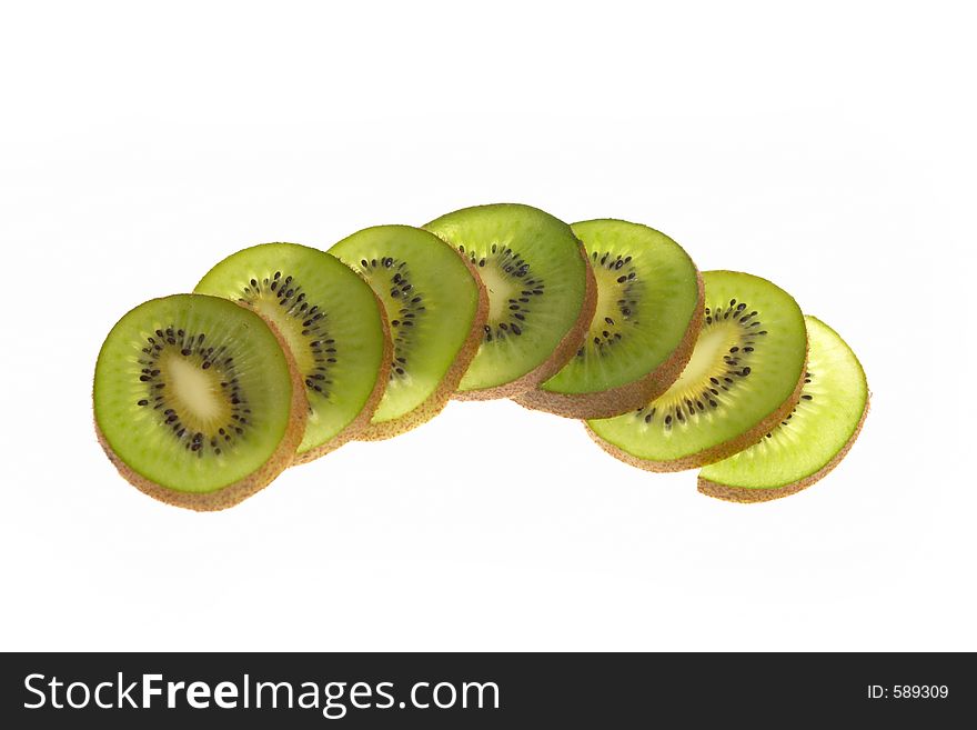 A sliced kiwi spread out across a table