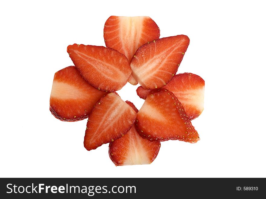 A kiwi surrounded by sliced strawberries