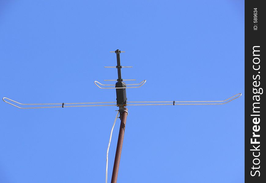 Antenna on blue sky background.