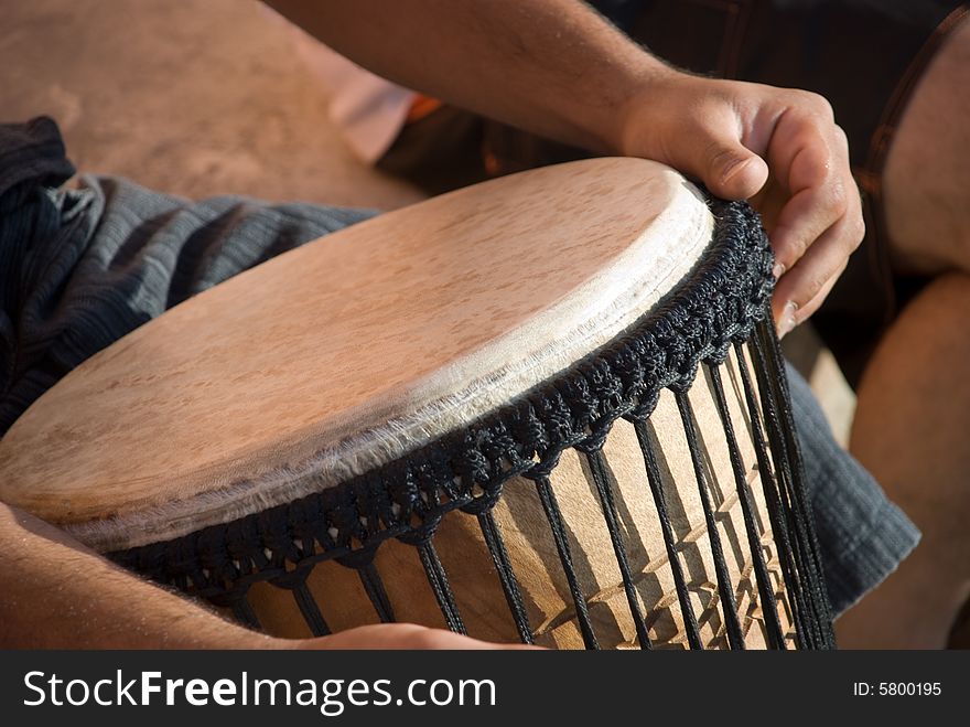 A musician plaing a drum