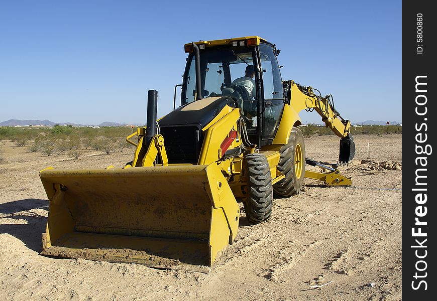 A giant steam shovel is about to dig into the dirt.  Horizontally framed shot. A giant steam shovel is about to dig into the dirt.  Horizontally framed shot.