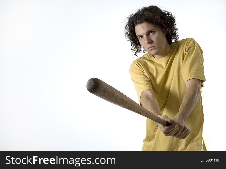 Man holding a baseball bat wearing a very serious expression on his face. Horizontally framed photograph. Man holding a baseball bat wearing a very serious expression on his face. Horizontally framed photograph