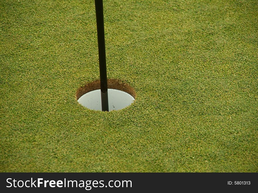 Golf hole with flag in it