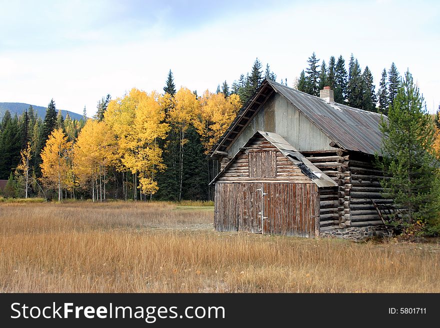An old log building in a colorful setting