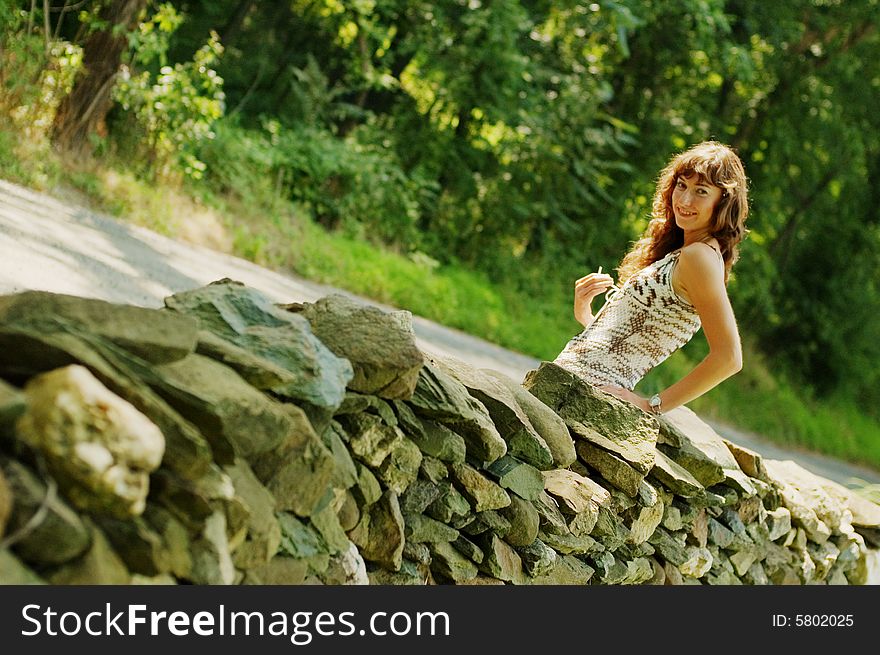 Pretty Girl Next To Stone Fence