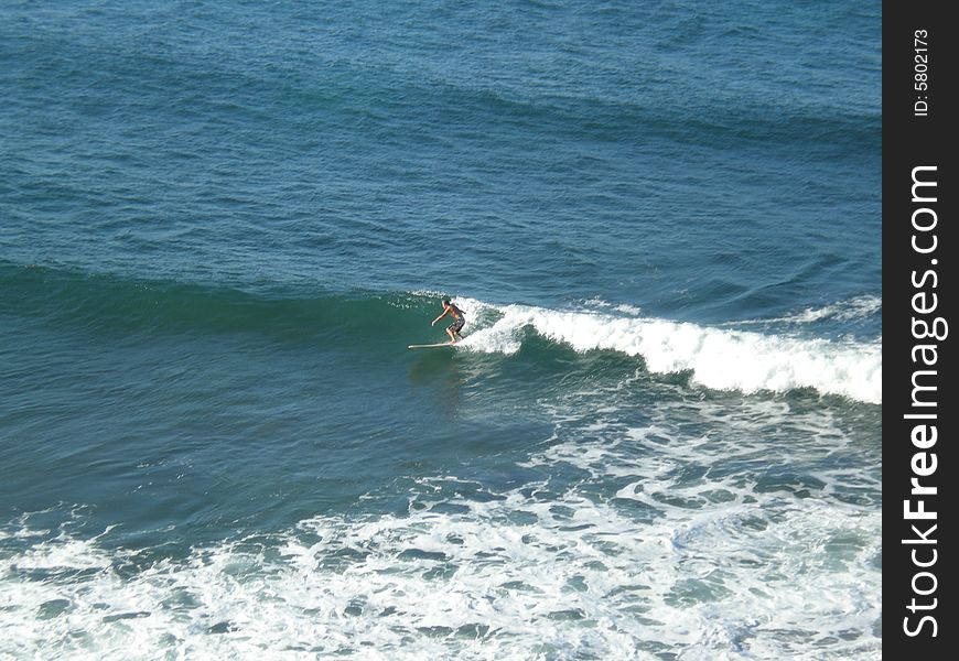 A lone surfer at Moffatt beach, in Queensland Australia