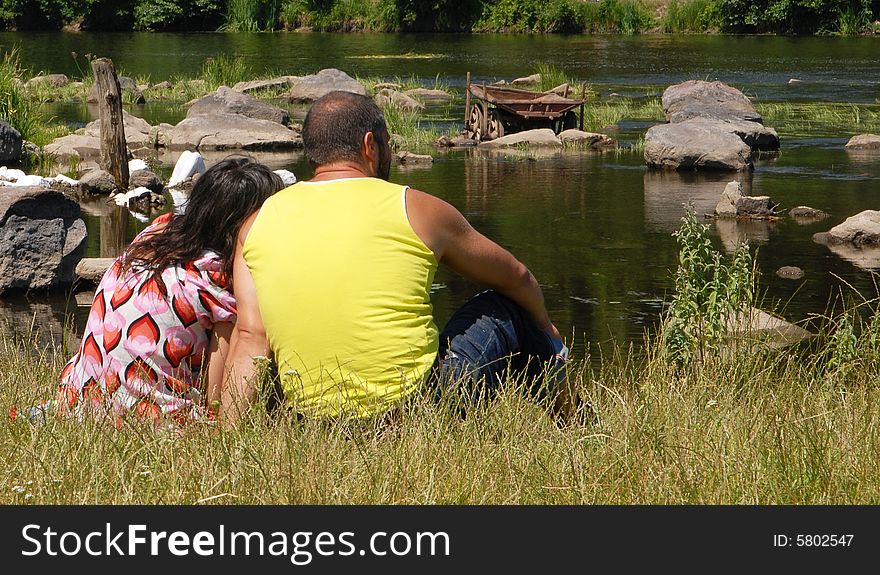 Man with woman on a river-bank. Man with woman on a river-bank