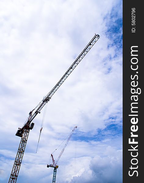 Long construction crane with blue sky as background. Long construction crane with blue sky as background