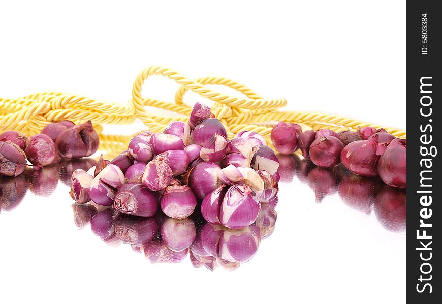 Peeled red onions composition with gold rope. Peeled red onions composition with gold rope