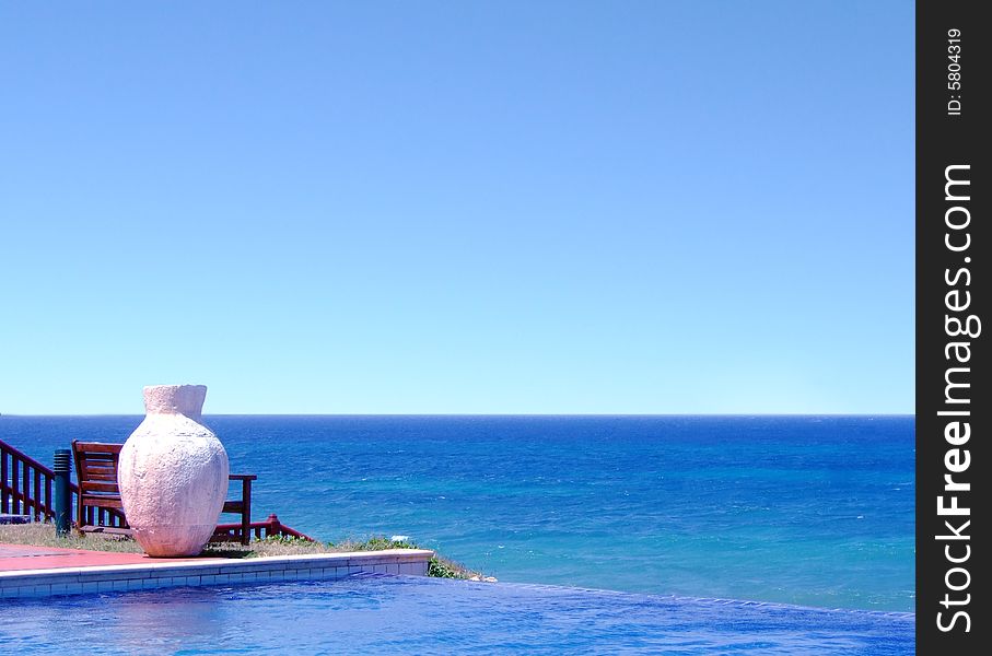 Pool with a sea view and white pot. Pool with a sea view and white pot