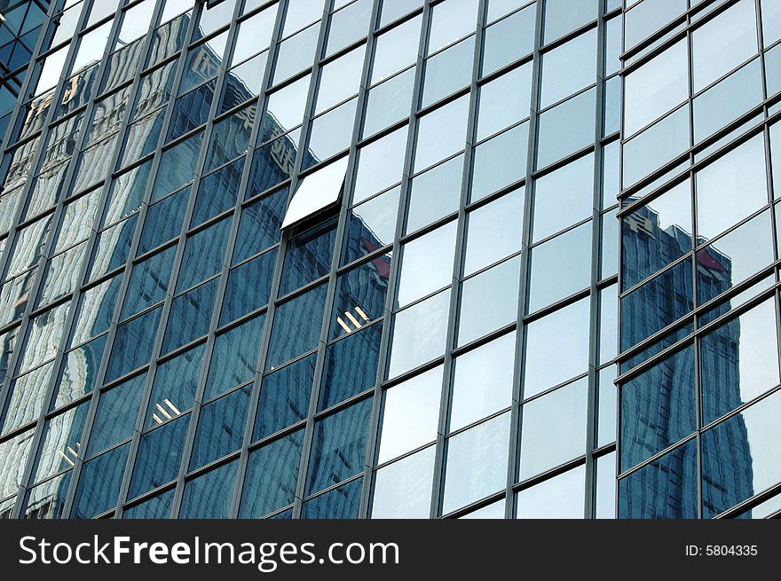 China, modern Chinese skyscrapers close photos - visable windows, glass panels, reflections, walls. China, modern Chinese skyscrapers close photos - visable windows, glass panels, reflections, walls.