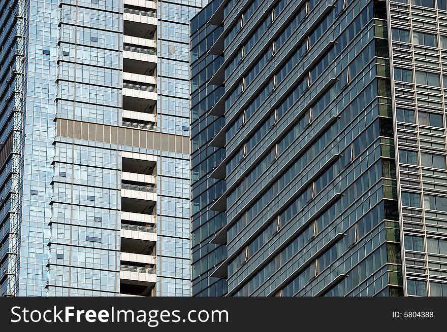 China, modern Chinese skyscrapers close photos - visable windows, glass panels, reflections, walls. China, modern Chinese skyscrapers close photos - visable windows, glass panels, reflections, walls.