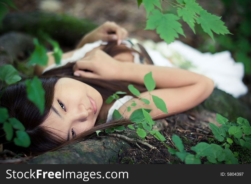 Beautiful asiatic girl dreaming in forest. Beautiful asiatic girl dreaming in forest