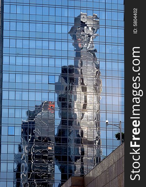 China, modern Chinese skyscrapers close photo showing reflection of another building in glass panels. China, modern Chinese skyscrapers close photo showing reflection of another building in glass panels.