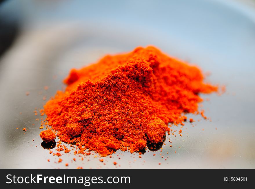 Sweet paprika powder on a black desk, with very vivid red color