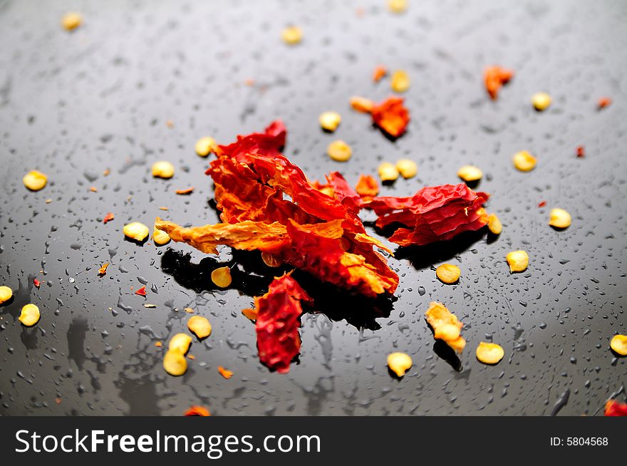 Dried red peppers composition with a dark humid background (water drops). Dried red peppers composition with a dark humid background (water drops)