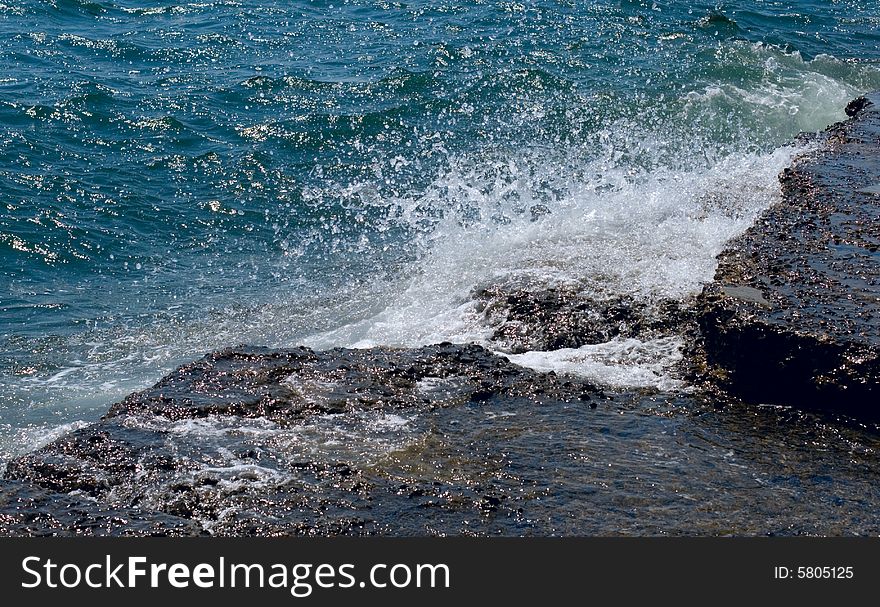 Stones, waves and sea foam. Stones, waves and sea foam