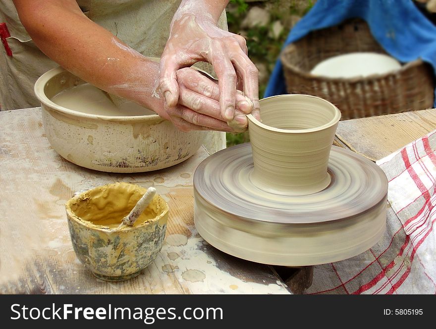 Hands of craftsman - potter in workshop.