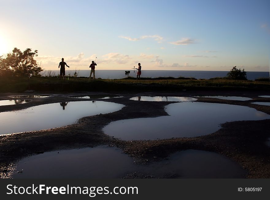 Pools and silhouettes of people on a coast of Baltic sea