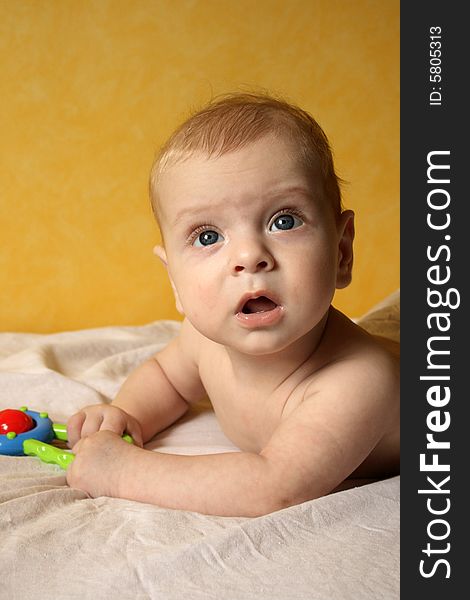 Clouse-up portret of baby boy on yellow background