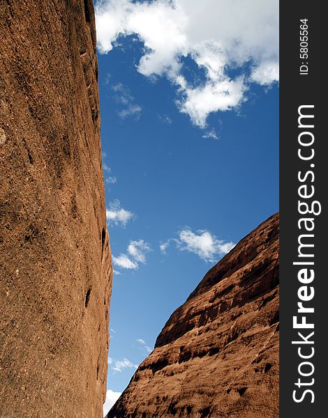 Detail of Kata Tjuta, a.k.a. the Olgas (Australia). It's showing the contrast between the red rock, heavenly blue sky and the white clouds.