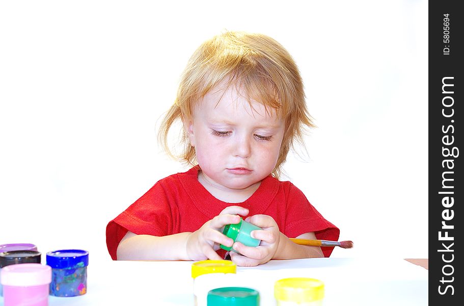 Little girl and paints isolated on white background