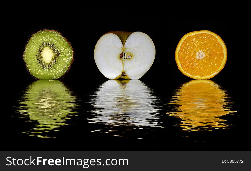 Kiwi, apple and orange isolated on bkack. Kiwi, apple and orange isolated on bkack