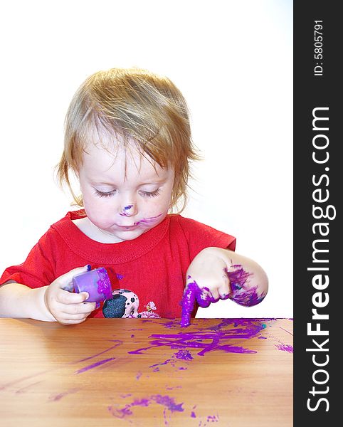 Little girl draws on a table isolated