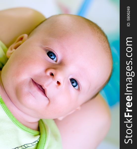 Seven week baby lying on mother's laps. Baby is smiling straight at camera. Seven week baby lying on mother's laps. Baby is smiling straight at camera.