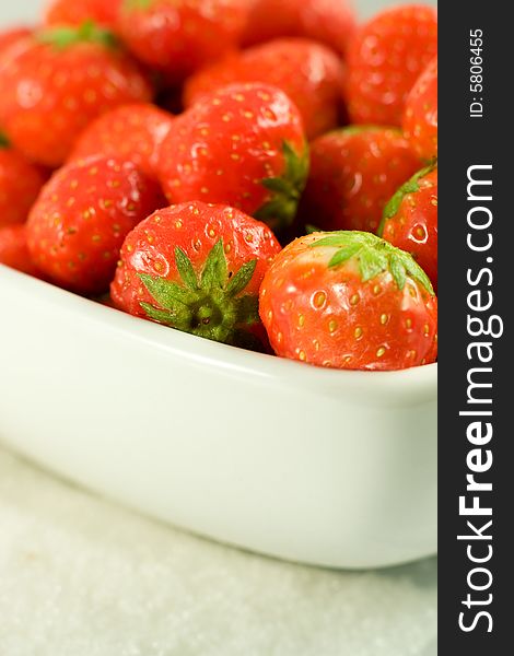 Strawberry in white bowl on white background. Strawberry in white bowl on white background