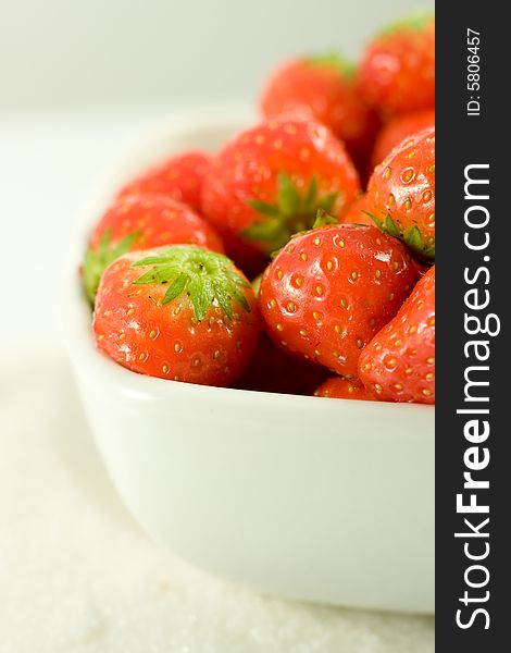 Strawberry in white bowl on white background. Strawberry in white bowl on white background