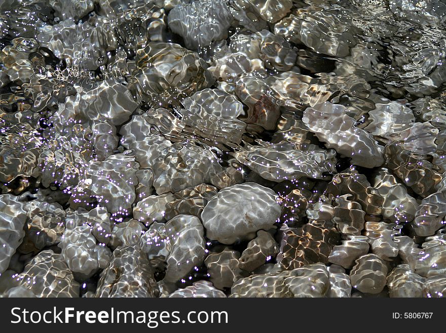 Pebbles and sparkling under seawater