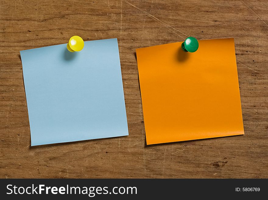 Two reminder notes with tacks on wooden surface. Two reminder notes with tacks on wooden surface.