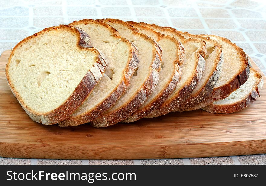 Fresh sliced Italian bread on a cutting board. Fresh sliced Italian bread on a cutting board.