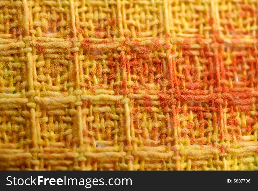 Macro pattern of colorful ( yellow, orange, red ) textile fabric