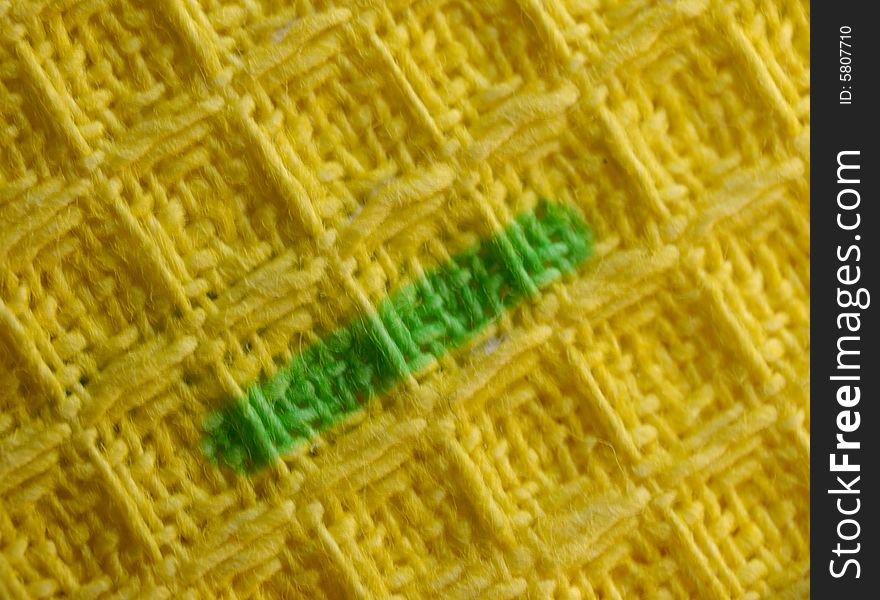 Macro pattern of yellow textile fabric with green strip