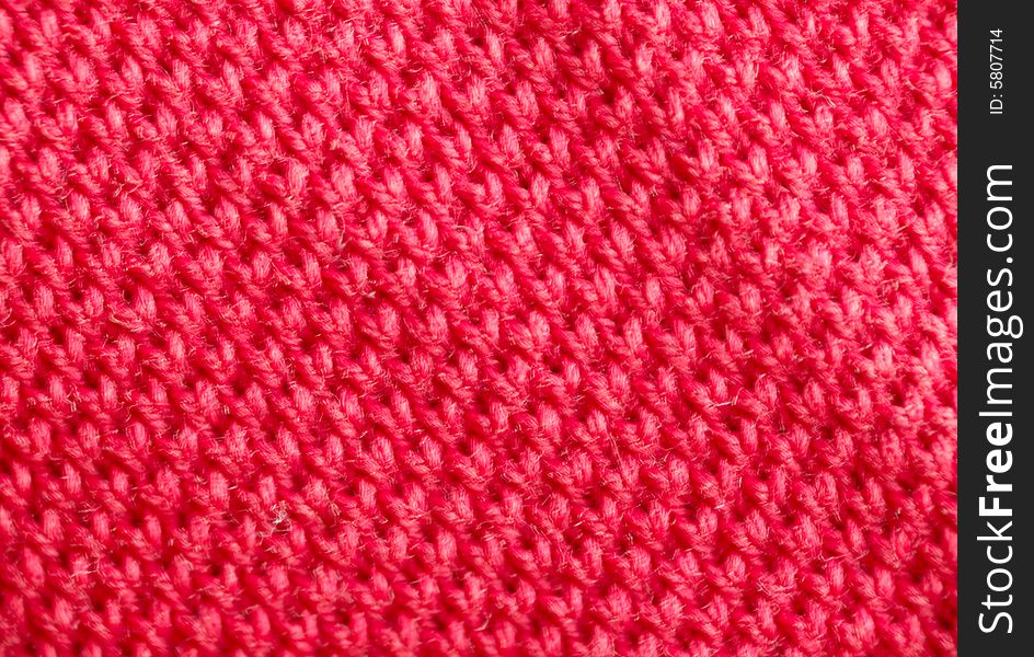 Macro pattern of red textile fabric .