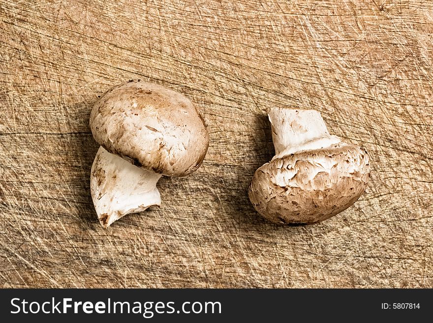 Two champignons on cutting table, close up shot.